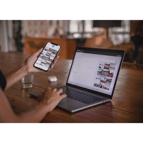 Reviewing investment listings on a phone and laptop