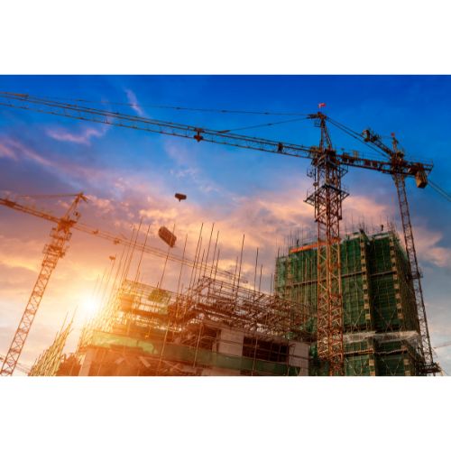 Apartment building under construction at sunset