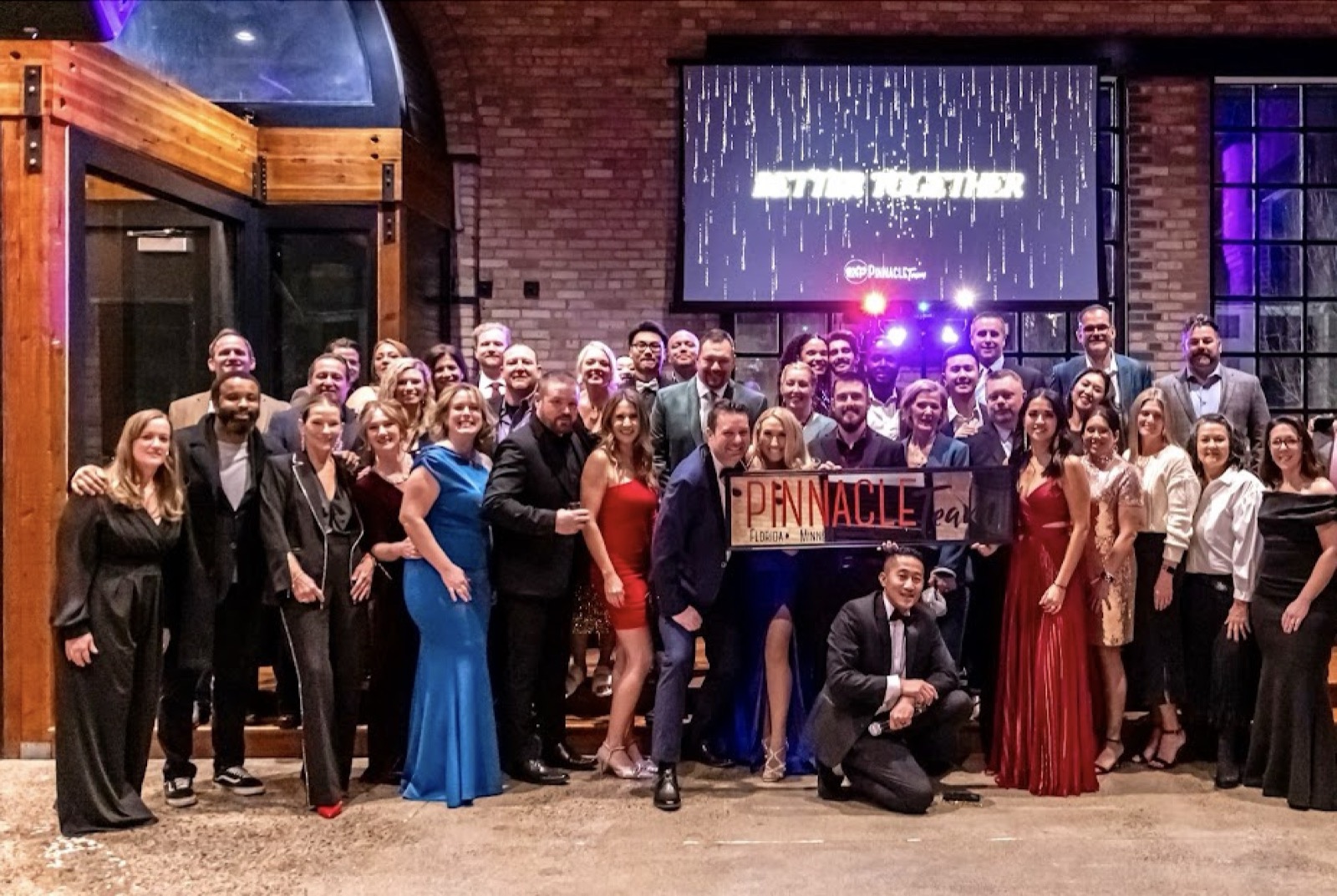 The Pinnacle Capital team celebrating together at a company gala